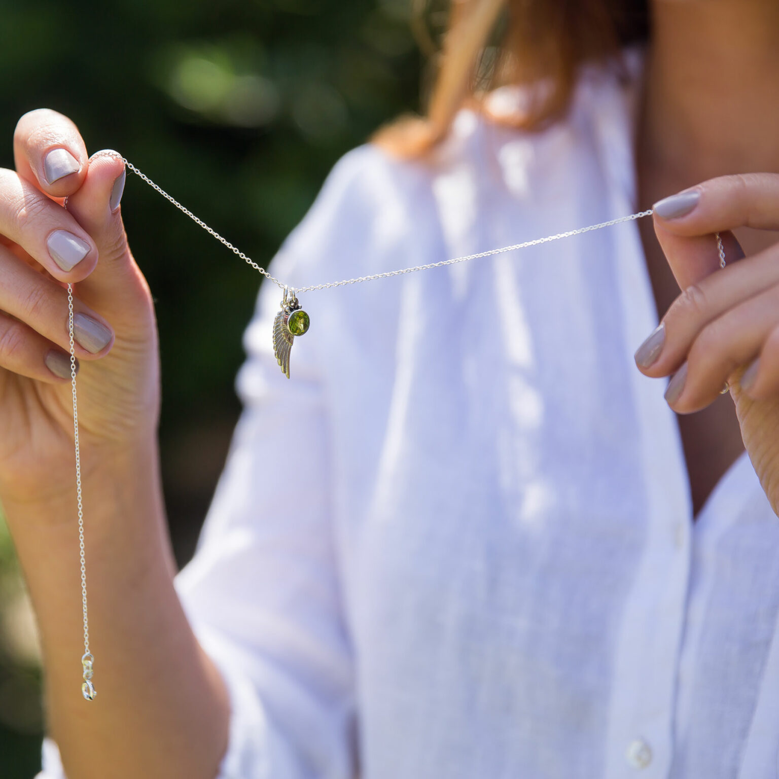Silver angel wing and peridot birthstone necklace
