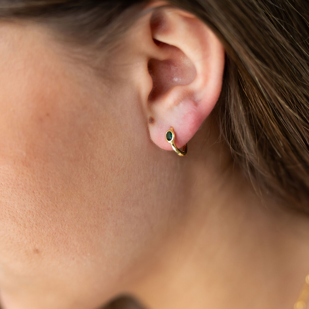 Emerald huggie earrings