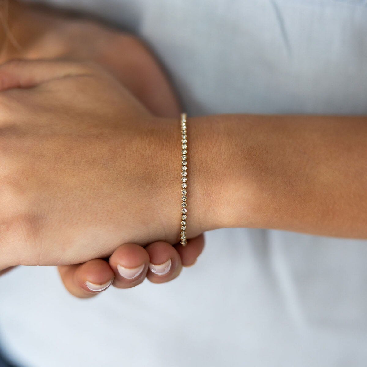 Gold-coloured tennis bracelet