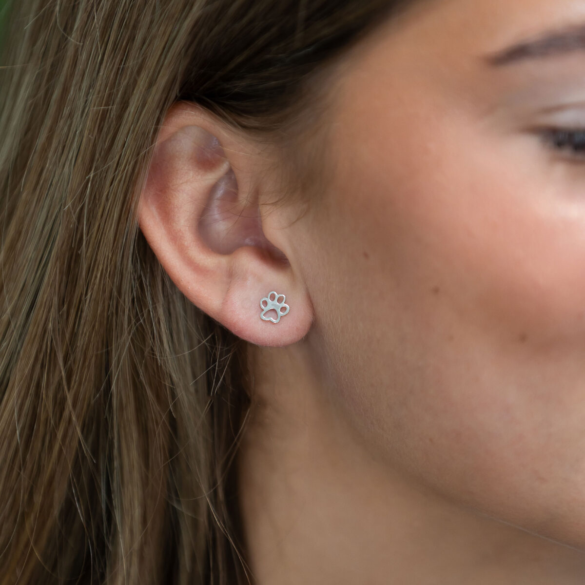 Silver cut-out dog paw stud earrings